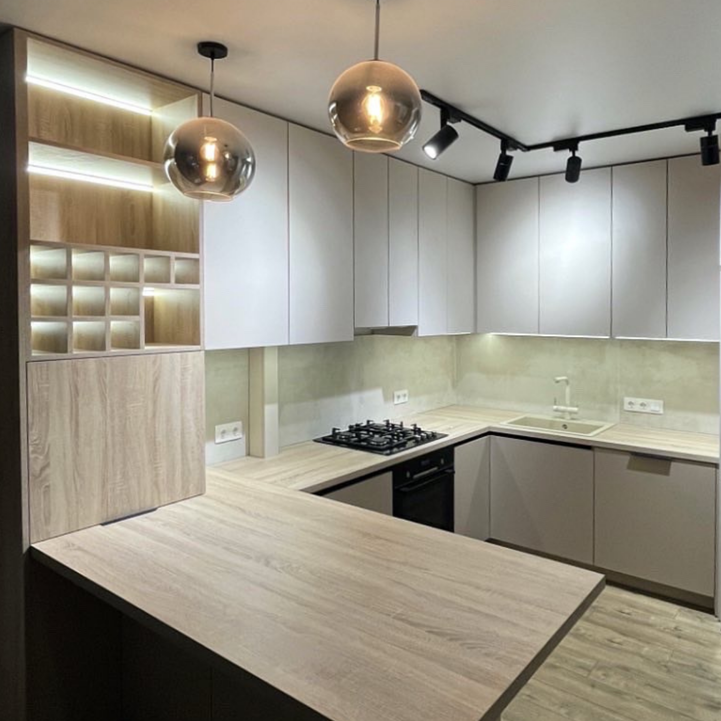 Modern kitchen with wooden island and white cabinets, featuring Arte Keukens logo.